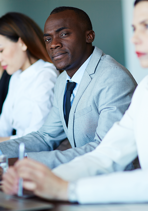 businessman-looking-at-camera-among-colleagues