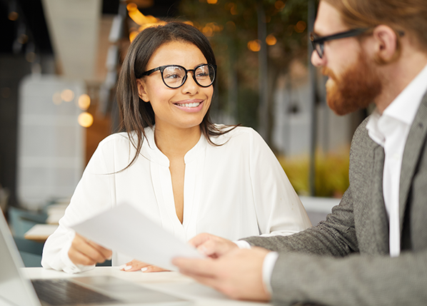 businesswoman-in-eyeglasses-sitting-at-table-with-businessman