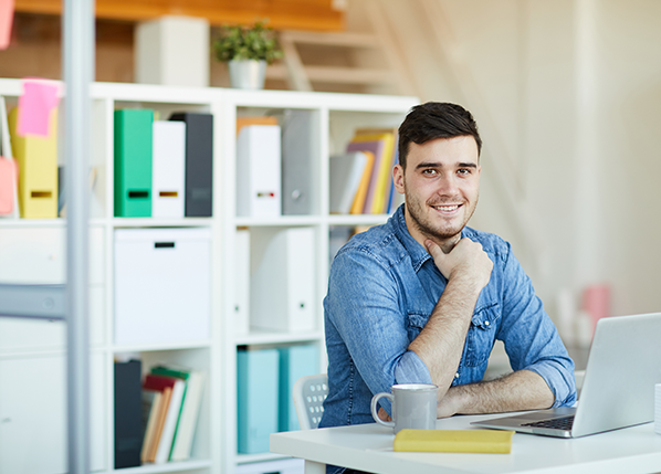 male-office-worker-sitting-by-desk