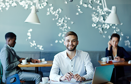 young-employee-working-while-sitting-in-cafe